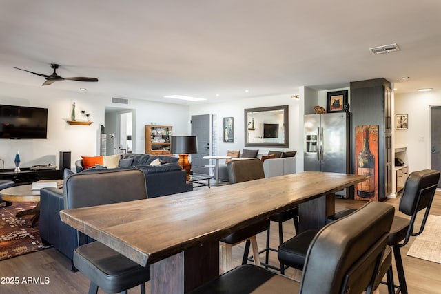 dining space featuring hardwood / wood-style flooring and ceiling fan