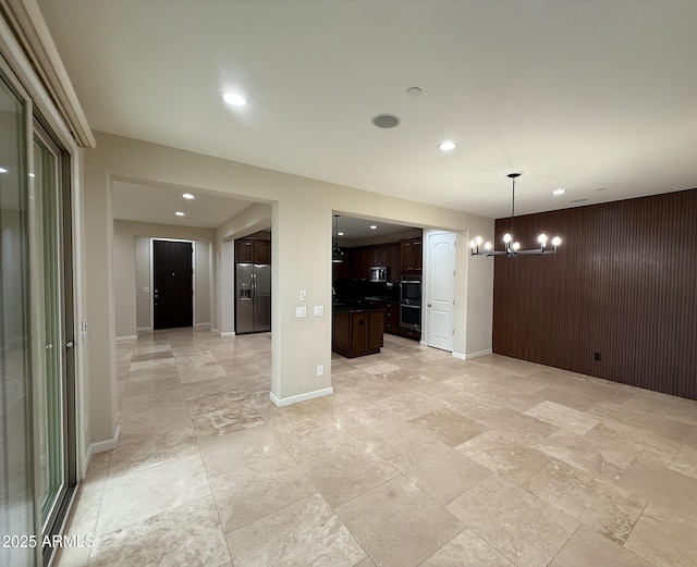 18515 N 94th St, Scottsdale, AZ 85255 - interior space featuring baseboards, recessed lighting, a chandelier, stone finish flooring, and wooden walls