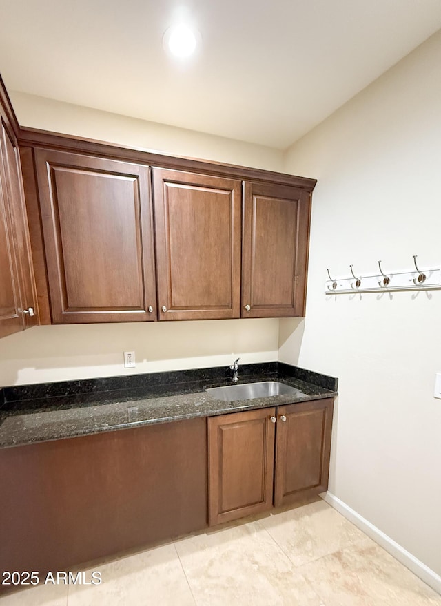 18515 N 94th St, Scottsdale, AZ 85255 - kitchen featuring dark stone counters, baseboards, and a sink