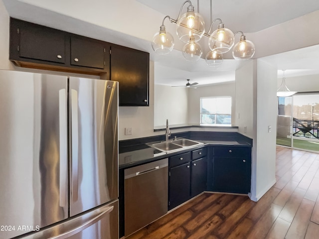 kitchen featuring ceiling fan, sink, dark hardwood / wood-style flooring, decorative light fixtures, and appliances with stainless steel finishes