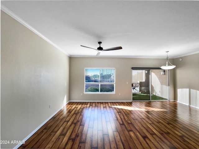 unfurnished living room with ceiling fan, crown molding, and dark wood-type flooring