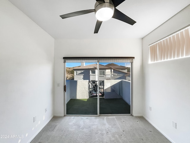 carpeted empty room featuring ceiling fan