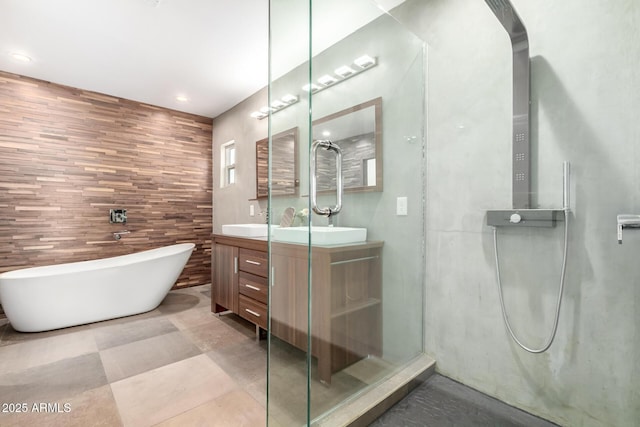 bathroom featuring double vanity, a shower with door, a sink, and a soaking tub
