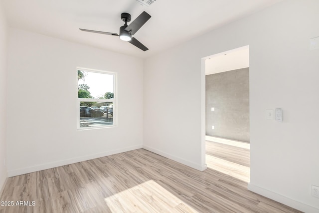 unfurnished room featuring light wood-style floors, baseboards, ceiling fan, and visible vents