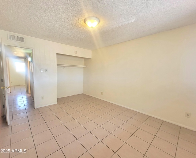 15602 N 55th Ave, Glendale, AZ 85306 - unfurnished bedroom featuring a textured ceiling, light tile patterned flooring, and a closet