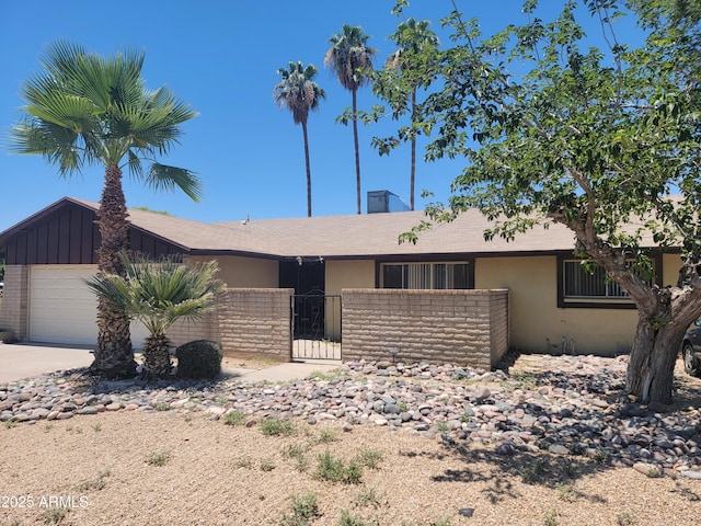 15602 N 55th Ave, Glendale, AZ 85306 - single story home with a fenced front yard, an attached garage, concrete driveway, board and batten siding, and stucco siding