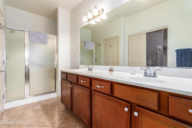 bathroom featuring vanity, tile patterned flooring, and a shower with shower door