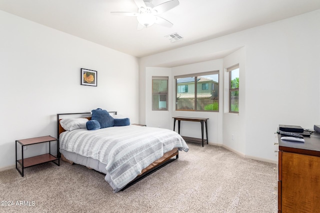 bedroom with ceiling fan and light colored carpet