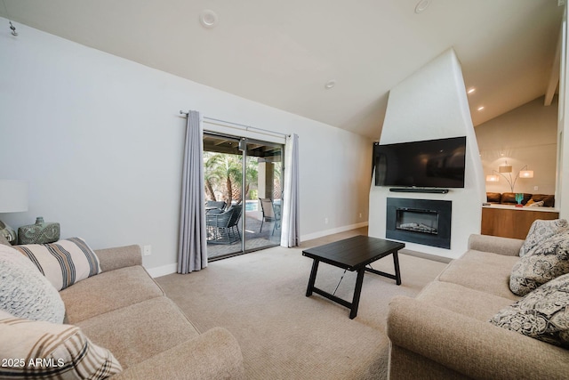 living area with a glass covered fireplace, vaulted ceiling, light colored carpet, and baseboards