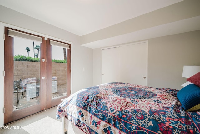 carpeted bedroom with french doors, access to outside, and a closet