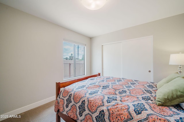 carpeted bedroom featuring a closet and baseboards