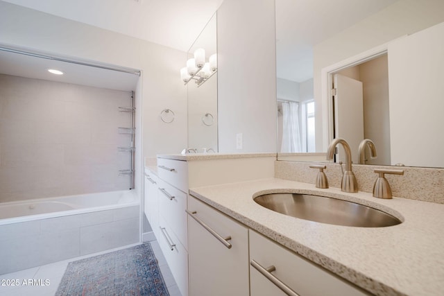 bathroom featuring tile patterned floors, vanity, and tiled shower / bath combo