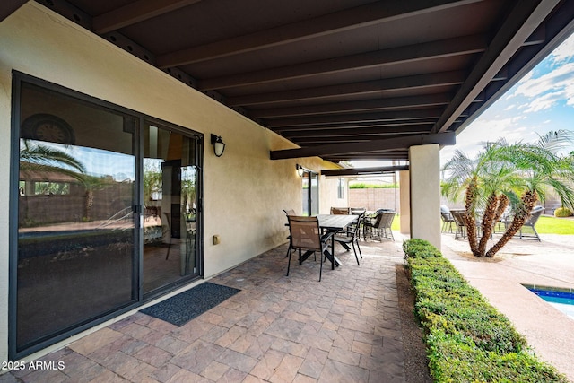 view of patio featuring fence and outdoor dining space