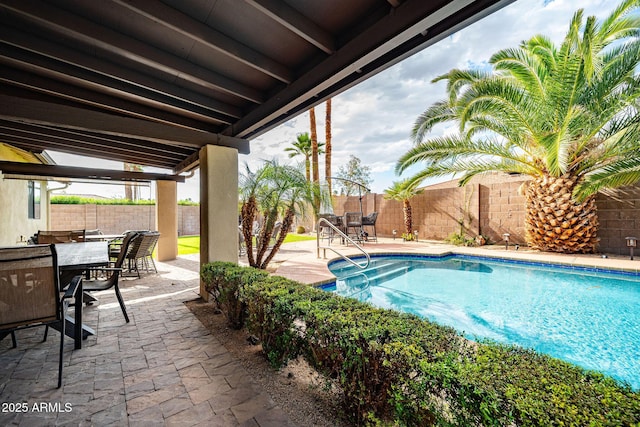 view of swimming pool featuring outdoor dining area, a fenced in pool, a fenced backyard, and a patio area