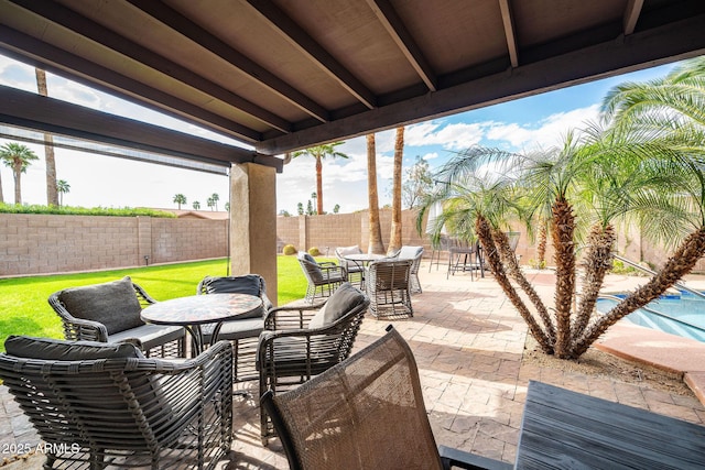 view of patio with a fenced in pool, outdoor dining space, and a fenced backyard