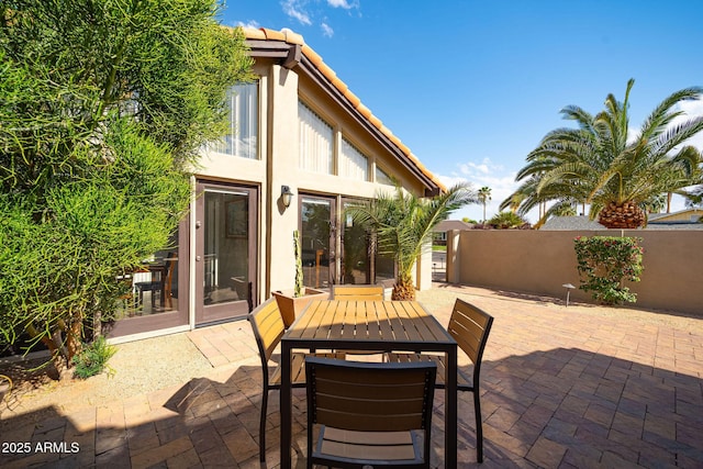 view of patio with fence and outdoor dining area