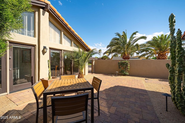 view of patio / terrace featuring fence and outdoor dining space