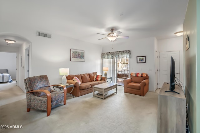 carpeted living room featuring ceiling fan