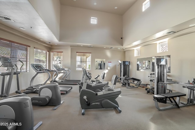 gym with a towering ceiling