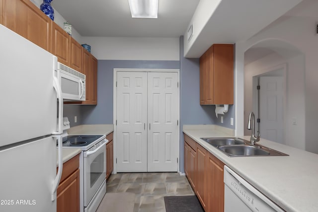 kitchen with sink and white appliances