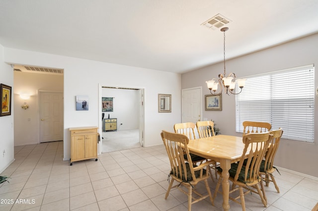 dining space with a notable chandelier and light tile patterned floors