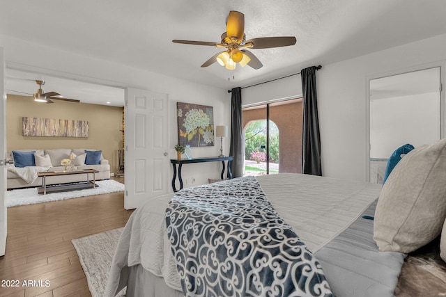 bedroom featuring wood-type flooring, ceiling fan, and access to outside