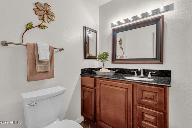 bathroom featuring double sink vanity and toilet