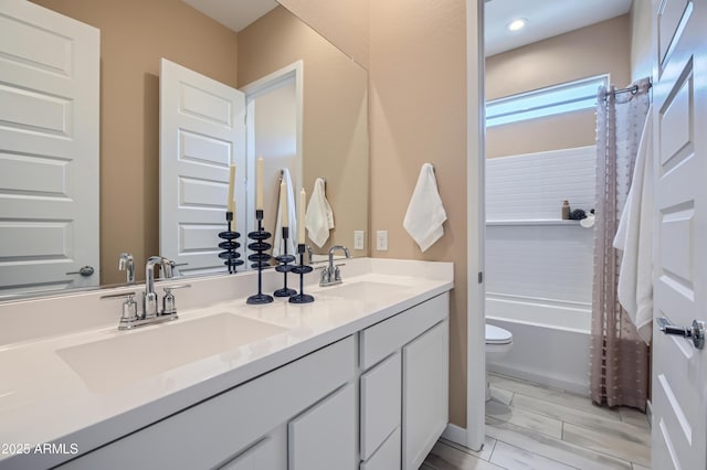 full bathroom with shower / bath combination with curtain, a sink, toilet, and double vanity