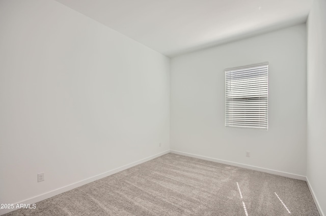 carpeted empty room with baseboards