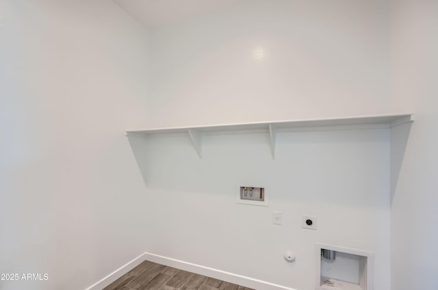 washroom featuring washer hookup, wood finished floors, hookup for an electric dryer, gas dryer hookup, and laundry area