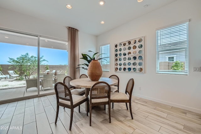 dining room featuring recessed lighting, baseboards, plenty of natural light, and light wood-style floors