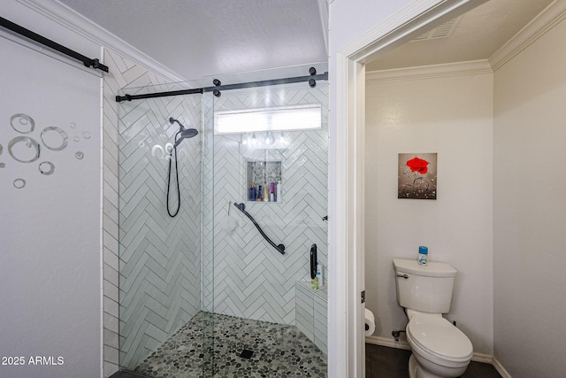 bathroom featuring toilet, a shower with door, and ornamental molding