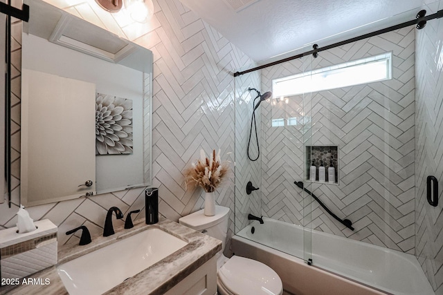 full bathroom with decorative backsplash, vanity, toilet, and bath / shower combo with glass door