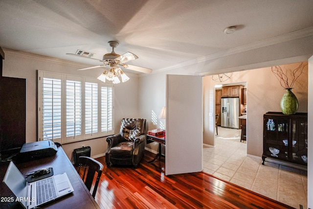 office space featuring light hardwood / wood-style floors, ceiling fan, and crown molding