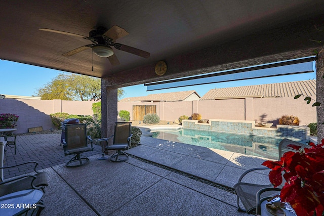 view of patio featuring a fenced in pool and ceiling fan