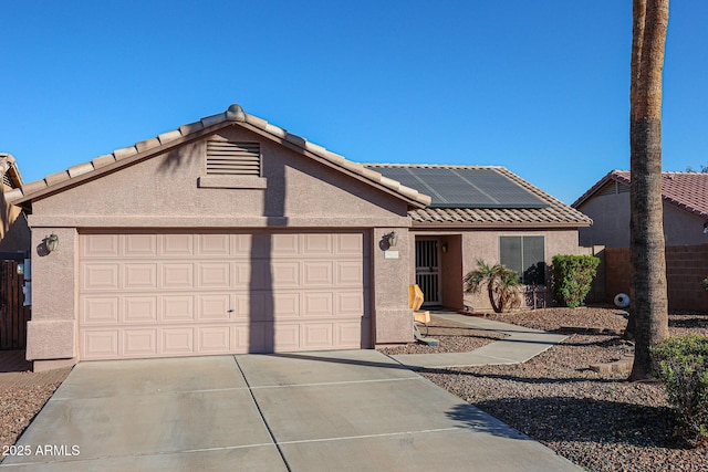 ranch-style house featuring solar panels and a garage