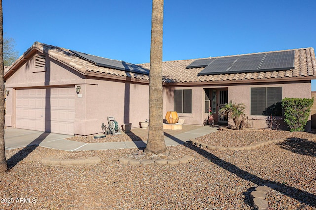 view of front of house with solar panels and a garage