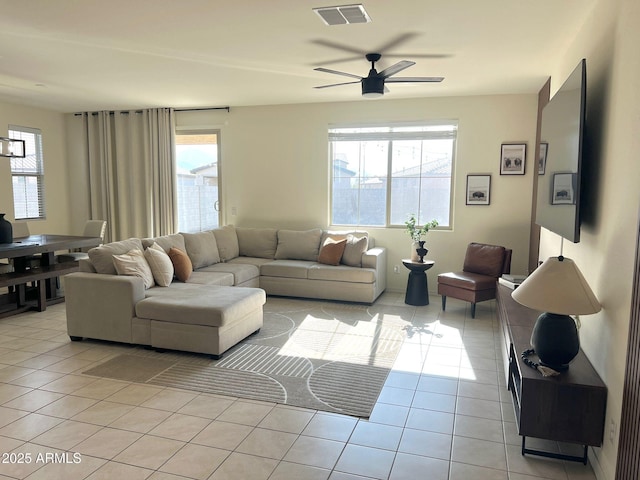 tiled living room with ceiling fan