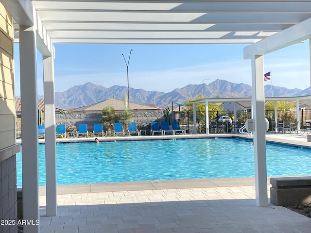 view of swimming pool with a mountain view