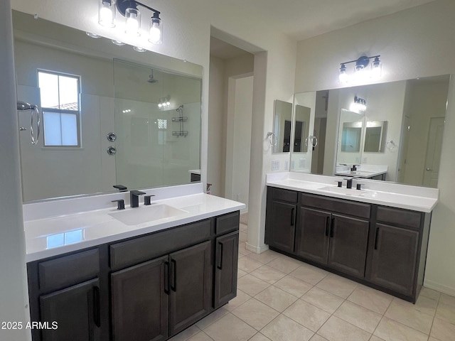 bathroom with tiled shower, tile patterned floors, and vanity