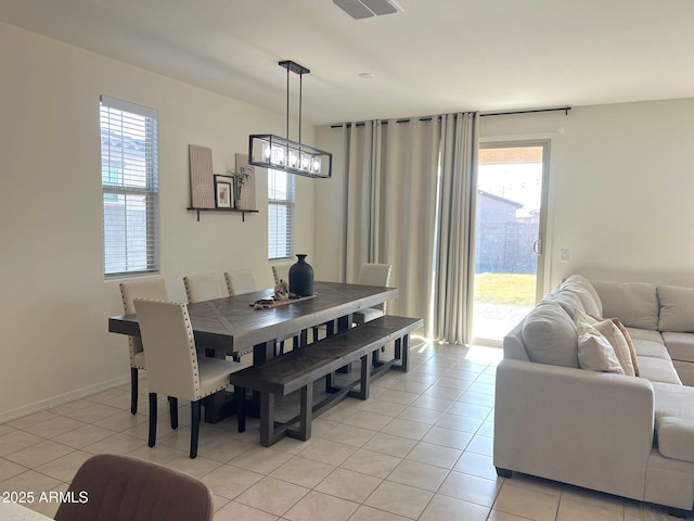 dining room featuring light tile patterned flooring and a chandelier