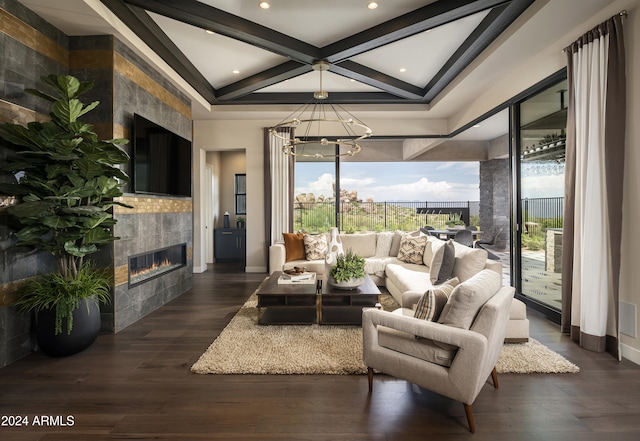 living room featuring beam ceiling, dark hardwood / wood-style flooring, coffered ceiling, and a tiled fireplace