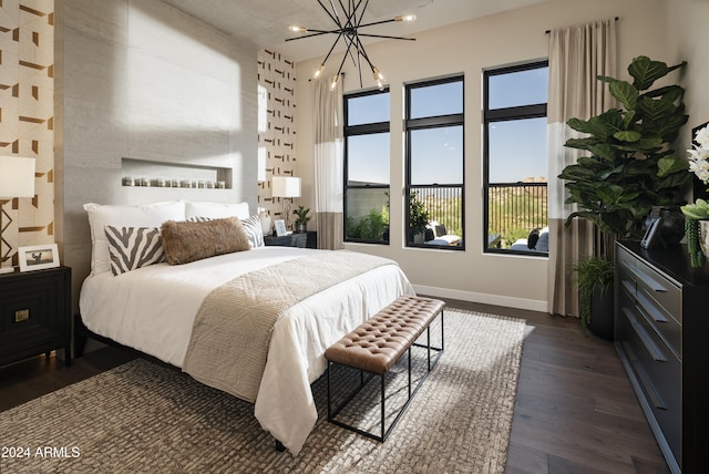 bedroom with an inviting chandelier and dark wood-type flooring