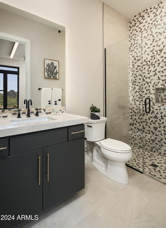 bathroom featuring tile patterned flooring, vanity, toilet, and an enclosed shower