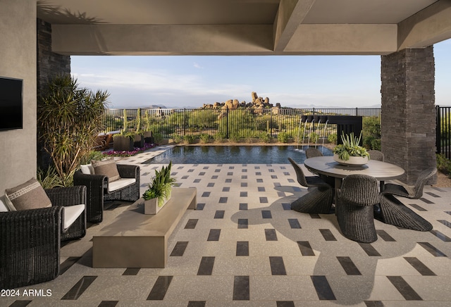 view of patio / terrace with pool water feature, a fenced in pool, and a water view