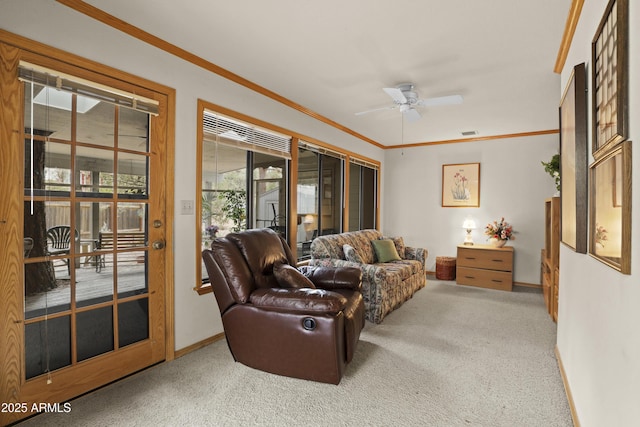 carpeted living room with a ceiling fan, visible vents, crown molding, and baseboards