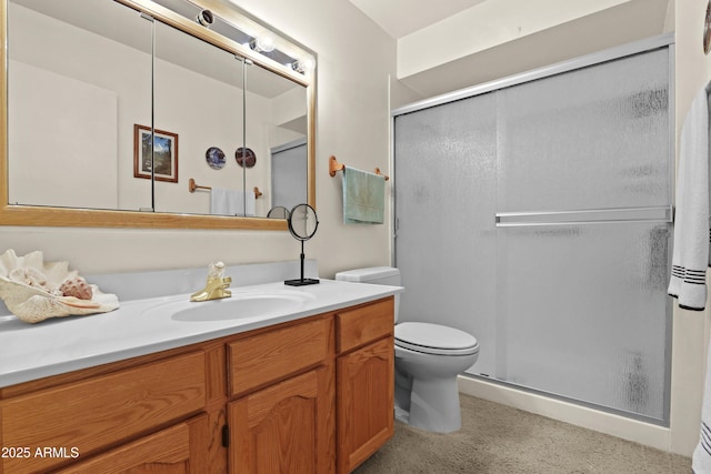 bathroom featuring toilet, a stall shower, and vanity