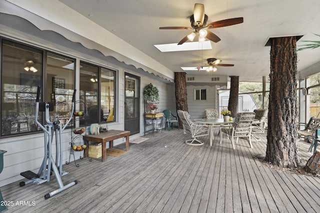 wooden terrace with outdoor dining space and a ceiling fan