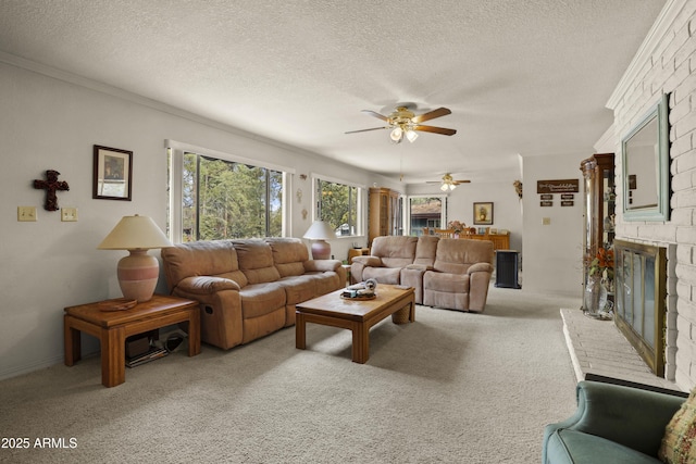 living area featuring a brick fireplace, light carpet, crown molding, and a textured ceiling