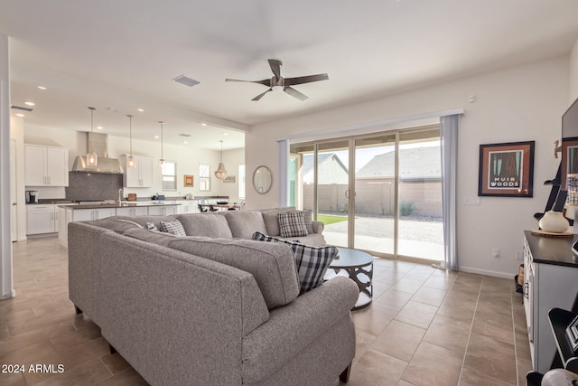 tiled living room with ceiling fan